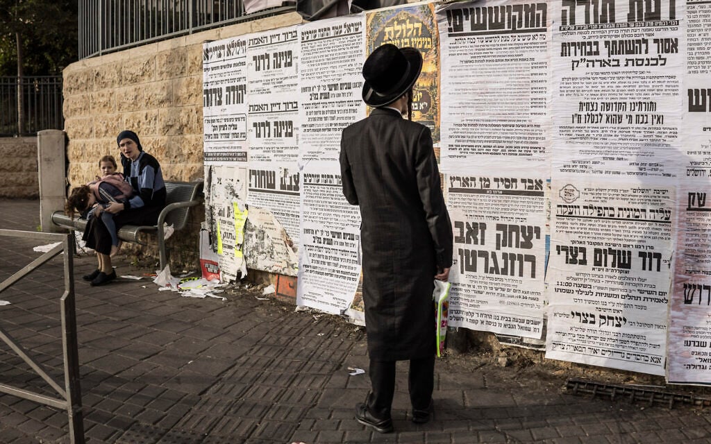 An ultra-Orthodox Jewish man looks at a notice board in Jerusalem on October 21, 2026. (JOHN WESSELS/AFP)
