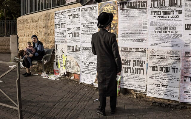 An ultra-Orthodox Jewish man looks at a notice board in Jerusalem on October 21, 2026. (JOHN WESSELS/AFP)