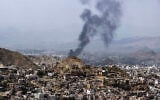 Smoke billows from a site that was targeted during battles between Saudi-backed Yemeni government fighters and Yemen’s Iran-backed Houthis at the Jabal Han front, west of the city of Taiz, on October 21, 2026 (AFP/File)
