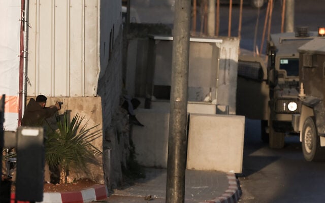 Two Palestinian gunmen amid an exchange fire with Israeli troops after a shooting attack at a checkpoint near Hebron, in the West Bank, on October 23, 2026. (HAZEM BADER/AFP)