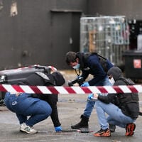 Police officers look at evidences on a site of a petrol station where a man opened fire from his car, killing one person and injuring four others according to police sources, in Trappes, Paris’ suburb on October 23, 2026. (Dimitar DILKOFF/AFP)