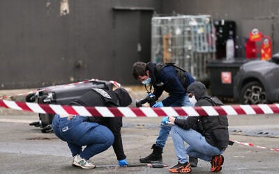 Police officers look at evidences on a site of a petrol station where a man opened fire from his car, killing one person and injuring four others according to police sources, in Trappes, Paris’ suburb on October 23, 2026. (Dimitar DILKOFF/AFP) Police officers look at evidences on a site of a petrol station where a man opened fire from his car, killing one person and injuring four others according to police sources, in Trappes, Paris’ suburb on October 23, 2026. (Dimitar DILKOFF/AFP)