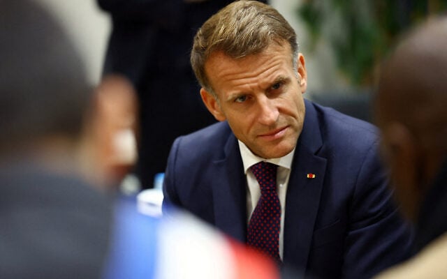 France’s President Emmanuel Macron meets with community members at the town hall following a shooting in Trappes, near Paris on October 23, 2026. (Hannah McKay/POOL/AFP)