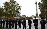 Police officers stand guard at the Place de la Bastille with The July Column in the background ahead of a demonstration in Paris on October 24, 2026 (Aris MESSINIS/AFP)