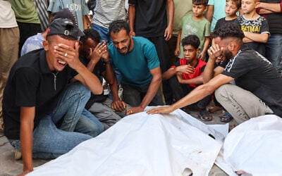 Mourners grieve next to the bodies of three Palestinians during their funeral at Al-Shifa Hospital in Gaza City on October 25, 2026, after they were reportedly killed in an Israeli strike on the Islamic University building. (Omar AL-QATTAA/AFP) Mourners grieve next to the bodies of three Palestinians during their funeral at Al-Shifa Hospital in Gaza City on October 25, 2026, after they were reportedly killed in an Israeli strike on the Islamic University building. (Omar AL-QATTAA/AFP)