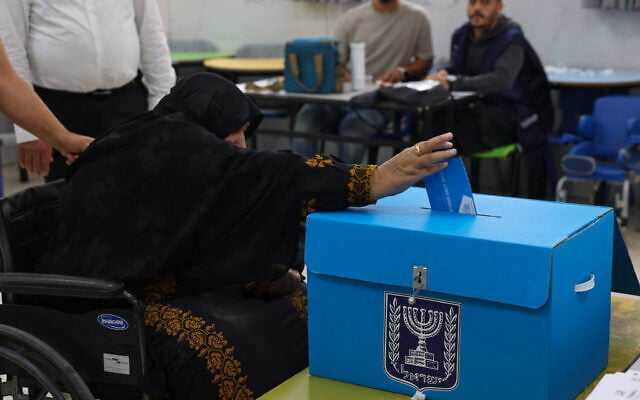 An elderly woman casts her ballot at a polling station in the southern Bedouin city of Rahat on October 27, 2026 during Israel’s legislative election. (HAZEM BADER/AFP)