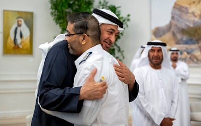 This handout picture provided by the UAE Presidential Court shows UAE President Sheikh Mohamed bin Zayed Al-Nahyan embracing flydubai pilot Smit Machchhar, during a reception for him and other crew members of Flight 1073 in Abu Dhabi on October 27, 2026. (Abdulla AL-NEYADI/UAE PRESIDENTIAL COURT/AFP)