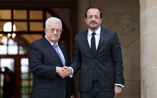 This handout photograph provided by the Palestinian Authority’s press office (PPO) on October 29, 2026, shows Cyprus’ President Nikos Christodoulides (R) receiving Palestinian President Mahmud Abbas before their meeting in Nicosia. (Thaer GHANAIM/PPO/AFP)