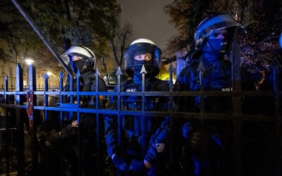 Police officers stand behind the fence with a rosary hanging on it as protesters gather outside the headquarters of Poland’s Constitutional Court in Warsaw after police blocked access to the court building on October 30, 2026. (Wojtek RADWANSKI/AFP) Police officers stand behind the fence with a rosary hanging on it as protesters gather outside the headquarters of Poland’s Constitutional Court in Warsaw after police blocked access to the court building on October 30, 2026. (Wojtek RADWANSKI/AFP)