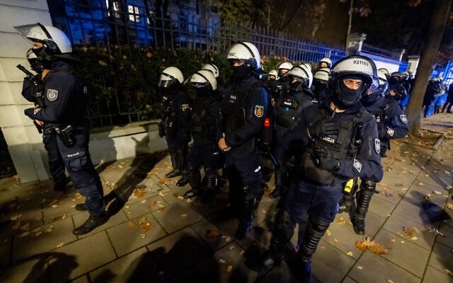 Police officers stand on alert as protesters gather outside the headquarters of Poland’s Constitutional Court in Warsaw after police blocked access to the building on October 30, 2026. (Wojtek RADWANSKI/AFP)
