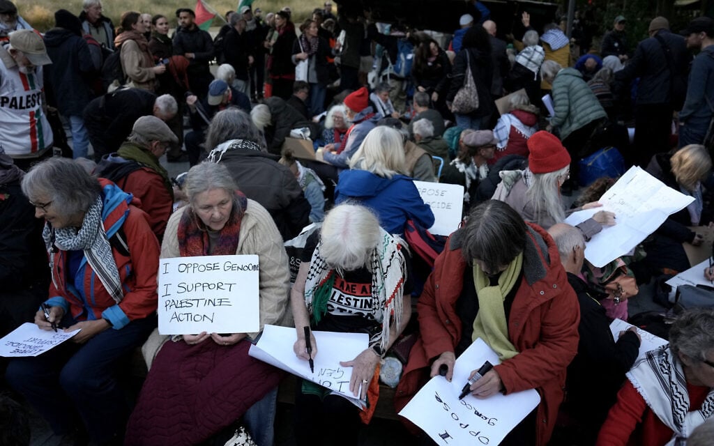 Pro-Palestinian, anti-Israel activists and supporters write on placards during a protest in support of Palestine Action, which the UK government has proscribed as a terror group, outside the US Embassy in London on October 31, 2026. (Carlos Jasso/AFP) Pro-Palestinian, anti-Israel activists and supporters write on placards during a protest in support of Palestine Action, which the UK government has proscribed as a terror group, outside the US Embassy in London on October 31, 2026. (Carlos Jasso/AFP)