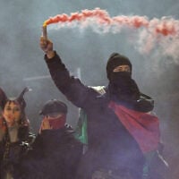 Protesters light smoke flares after a demonstration organised by “GenZ regelt!” (Gen Z has got this!) in Berlin on October 31, 2026. (RALF HIRSCHBERGER/AFP)