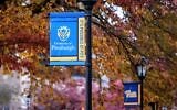 Autumn foliage frame banners on the campus of the University of Pittsburgh campus in Pittsburgh, November 10, 2025. (Gene J. Puskar/AP)