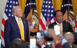 FILE: US President Donald Trump listens as Leo Terrell speaks during a Black History Month event in the East Room of the White House, February 18, 2026, in Washington. (AP Photo/Nathan Howard)