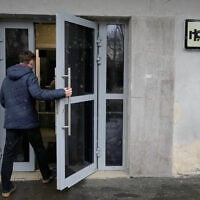 A man enters a building where independent Russian newspaper Novaya Gazeta has an office in Moscow, Russia, on April 9, 2026. (AP Photo/Pavel Bednyakov)