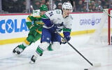 Vancouver Canucks defenseman Zeev Buium (24) skates with the puck during the first period of an NHL hockey game April 2, 2026, in St. Paul, Minn. (AP Photo/Matt Krohn)