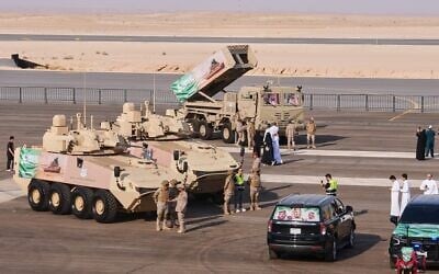Saudi military personnel and visitors gather near armored vehicles on display before the start of an air show and military parade marking Saudi National Day in Malham, north of Riyadh, Saudi Arabia, September 22, 2026. (AP Photo/Baraa Anwer)