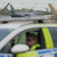 A B1 bomber prepares to take off as police officers man a checkpoint near RAF Fairford air base, in Fairford, England September 29, 2026. (AP Photo/Alastair Grant)