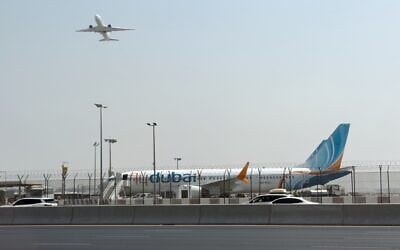 A plane takes off as a flydubai aircraft sits on the tarmac at Dubai International Airport in Dubai, United Arab Emirates, September 30, 2026. (AP Photo) A plane takes off as a flydubai aircraft sits on the tarmac at Dubai International Airport in Dubai, United Arab Emirates, September 30, 2026. (AP Photo)
