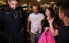 Israeli passenger Yaniv Hayoun, with blood stains on his shirt, who was aboard a Flydubai aircraft that made an emergency landing in Saudi Arabia, is welcomed at the arrivals gate at Ben Gurion International Airport near Tel Aviv, Israel, September 30, 2026. (AP Photo/Tomer Appelbaum)
