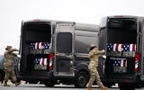 Door attendants secure the doors of the transfer vans containing the remains of US Army Reserve soldiers Maj. Jeffrey O’Brien, Maj. Cody Khork, Chief Warrant Officer 3 Robert Marzan, Master Sgt. Class Nicole Amor, Master Sgt. Class Noah Tietjens, Sgt. Declan Coady, during a casualty return, March 7, 2026, at Dover Air Force Base, Delaware, who were killed in a drone strike at a command center in Kuwait after the US and Israel launched its military campaign against Iran. (AP Photo/Mark Schiefelbein)