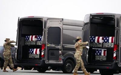 Door attendants secure the doors of the transfer vans containing the remains of US Army Reserve soldiers Maj. Jeffrey O’Brien, Maj. Cody Khork, Chief Warrant Officer 3 Robert Marzan, Master Sgt. Class Nicole Amor, Master Sgt. Class Noah Tietjens, Sgt. Declan Coady, during a casualty return, March 7, 2026, at Dover Air Force Base, Delaware, who were killed in a drone strike at a command center in Kuwait after the US and Israel launched its military campaign against Iran. (AP Photo/Mark Schiefelbein)