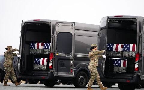 Door attendants secure the doors of the transfer vans containing the remains of US Army Reserve soldiers Maj. Jeffrey O’Brien, Maj. Cody Khork, Chief Warrant Officer 3 Robert Marzan, Master Sgt. Class Nicole Amor, Master Sgt. Class Noah Tietjens, Sgt. Declan Coady, during a casualty return, March 7, 2026, at Dover Air Force Base, Delaware, who were killed in a drone strike at a command center in Kuwait after the US and Israel launched its military campaign against Iran. (AP Photo/Mark Schiefelbein)