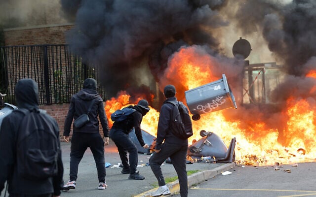 Students burn garbage as they protest to demand more resources at school, in Lille, France, October 1, 2026. (AP Photo/Jean-Francois Badias)
