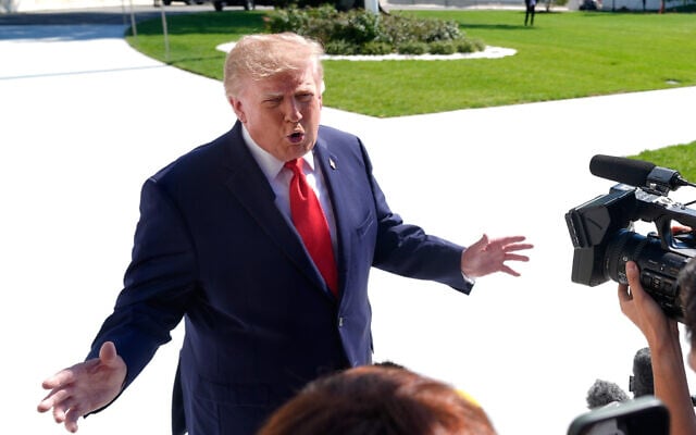 US President Donald Trump speaks to reporters before boarding Marine One as he leaves the White House, October 1, 2026, in Washington. (AP Photo/Manuel Balce Ceneta)