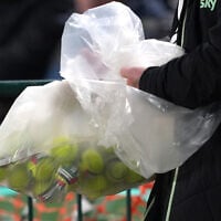 Tennis balls with stickers of the Palestine flag and the text, “#StopTheGame,” are removed from the field after being thrown by protesters during the UEFA Nations League, Group B3 match at the Aviva Stadium in Dublin, Ireland, on October 1, 2026. (Brian Lawless/PA via AP)