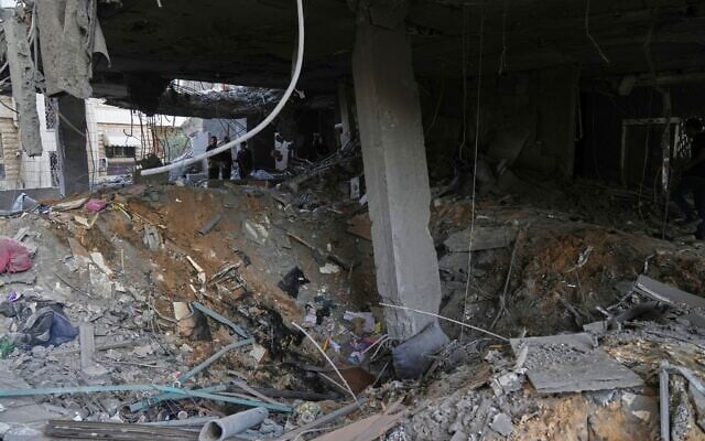Palestinians inspect the site of an early morning Israeli airstrike in Gaza city, October 3, 2026. (AP Photo/Jehad Alshrafi) Palestinians inspect the site of an early morning Israeli airstrike in Gaza city, October 3, 2026. (AP Photo/Jehad Alshrafi)