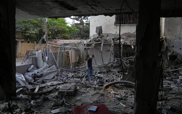 Palestinians inspect the site of an early morning Israeli airstrike in Gaza City, in the Strip's north, on October 3, 2026. (AP Photo/Jehad Alshrafi)