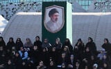 Volunteers sit under a portrait of the Iranian Supreme Leader Ayatollah Mojtaba Khamenei while attending a military training course at a camp set up in Imam Hussein Square in Tehran, Iran, on October 4, 2026. (AP Photo/Vahid Salemi)