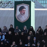 Volunteers sit under a portrait of the Iranian Supreme Leader Ayatollah Mojtaba Khamenei while attending a military training course at a camp set up in Imam Hussein Square in Tehran, Iran, on October 4, 2026. (AP Photo/Vahid Salemi)