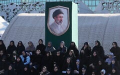 Volunteers sit under a portrait of the Iranian Supreme Leader Ayatollah Mojtaba Khamenei while attending a military training course at a camp set up in Imam Hussein Square in Tehran, Iran, on October 4, 2026. (AP Photo/Vahid Salemi)