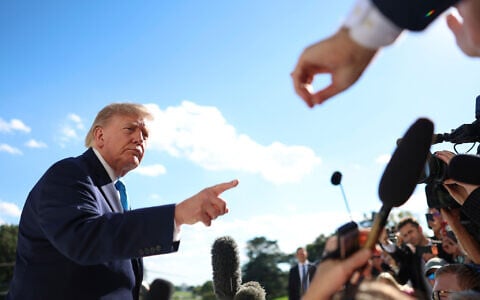 US President Donald Trump gestures as he speaks to reporters before boarding Marine One on the South Lawn of the White House, October 5, 2026, in Washington. (AP Photo/Tom Brenner)