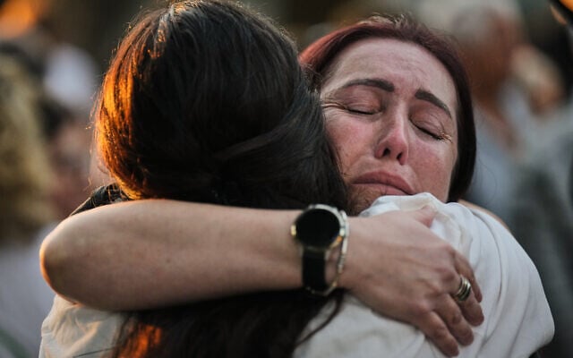 People attend a memorial service marking the third anniversary of the October 7, 2023, Hamas cross-border attack on Israel, in Kibbutz Kfar Aza, southern Israel, where many community members were killed and abducted, October 7, 2026. (AP Photo/Ariel Schalit)