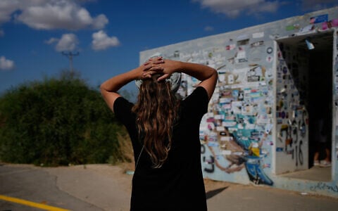 People visit a roadside bomb shelter where people were killed during the deadly October 7, 2023, Hamas attack along the Israel-Gaza border, as the country marks the third anniversary of the attack, near Kibbutz Reim, southern Israel, October 7, 2026. (AP Photo/Ohad Zwigenberg)