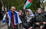 Pro Palestinian protesters clash with counterprotesters during a protest march marking three years since the Hamas-led October 7 attack on Israel in London, October 7, 2026. (AP Photo/Kin Cheung)