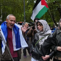 Pro Palestinian protesters clash with counterprotesters during a protest march marking three years since the Hamas-led October 7 attack on Israel in London, October 7, 2026. (AP Photo/Kin Cheung)