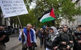 Pro-Palestinian, anti-Israel protesters encounter a pro-Israel protester during a march in London marking three years since 2023's Hamas-led invasion and massacre in Israel, October 7, 2026. (AP/Kin Cheung)