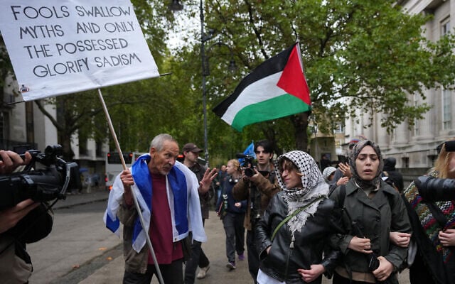 Pro-Palestinian, anti-Israel protesters encounter a pro-Israel protester during a march in London marking three years since 2023's Hamas-led invasion and massacre in Israel, October 7, 2026. (AP/Kin Cheung) Pro-Palestinian, anti-Israel protesters encounter a pro-Israel protester during a march in London marking three years since 2023's Hamas-led invasion and massacre in Israel, October 7, 2026. (AP/Kin Cheung)