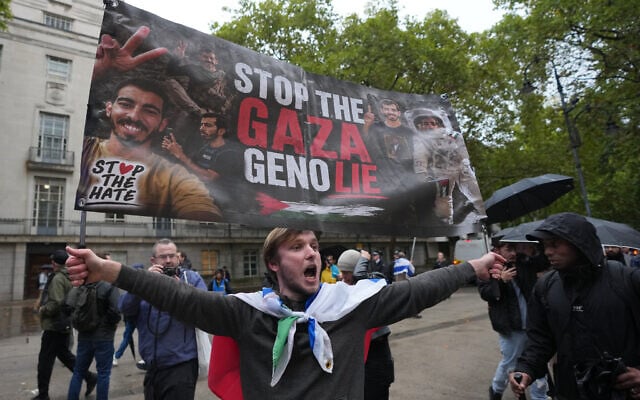 A protester holds a placard to demand an end to Israel's war in Gaza, marking three years since the October 7 attacks on Israel in London, October 7, 2026. (AP/Kin Cheung) A protester holds a placard to demand an end to Israel's war in Gaza, marking three years since the October 7 attacks on Israel in London, October 7, 2026. (AP/Kin Cheung)