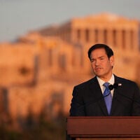 US Secretary of State Marco Rubio speaks at the Pnyx hill, where ancient Athenians held democratic assemblies, with the ancient Parthenon temple atop the Acropolis in the background, in Athens, October 7, 2026. (AP Photo/Mark Schiefelbein, Pool)