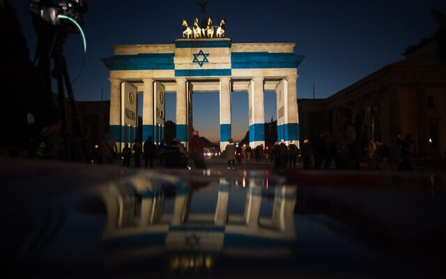 Germany’s landmark Brandenburg Gate is illuminated with the Israeli national flag, marking the third anniversary of October 7, in Berlin, Germany, October 7, 2026. (AP Photo/Markus Schreiber)