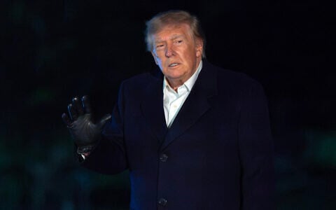 US President Donald Trump waves to reporters as he walks on the South Lawn upon his arrival to the White House, October 8, 2026, in Washington. (AP Photo/Jose Luis Magana)