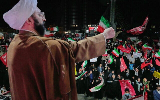 A cleric leads demonstrators in a pro-government gathering at a square in Tehran, October 8, 2026. (AP Photo/Vahid Salemi)