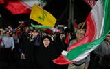 People wave the flags of Iran and its Lebanese proxy Hezbollah at a pro-regime rally in Tehran, Iran, on October 8, 2026. (AP Photo/Vahid Salemi)