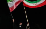 Demonstrators wave Iranian flags during a pro-government gathering at a square in Tehran, Iran, October 8, 2026. (AP Photo/Vahid Salemi)