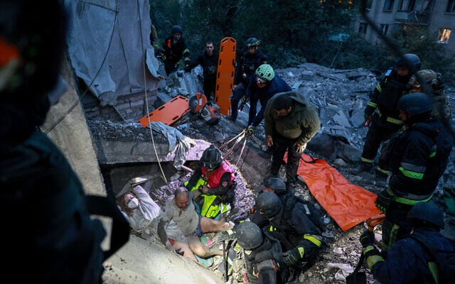 Rescue workers pull a family from the rubble of a residential building destroyed by a Russian airstrike in Zaporizhzhia, Ukraine, October 10, 2026. (AP Photo/Kateryna Klochko)
